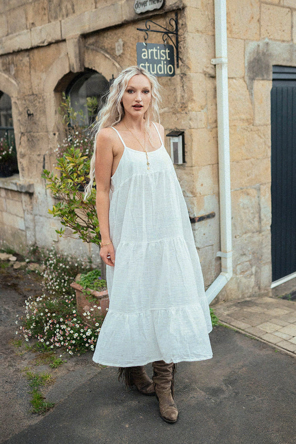 Model wears our Clover Midi Dress in Salt White. A simple folky flowing strappy midi with a full skirt all in a soft cotton gauze fabric by All About Audrey