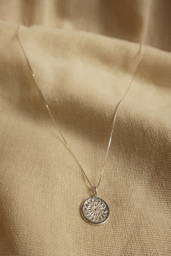 Silver Marigold Charm Necklace by All About Audrey