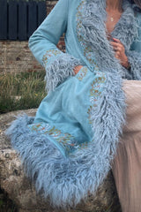 model wears fleetwood penny lane 70s faux suede coat hippy afghan faux fur jacket in baby blue with floral embroidery by all about audrey