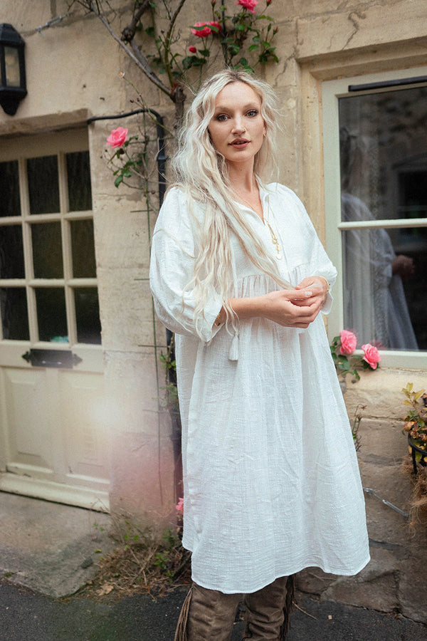 Model wears our Posy Midi Dress in Salt White. A bohemian vintage inspired smocked folky style, perfect for everyday or dressing up. All in a soft cotton gauze fabric by All About Audrey